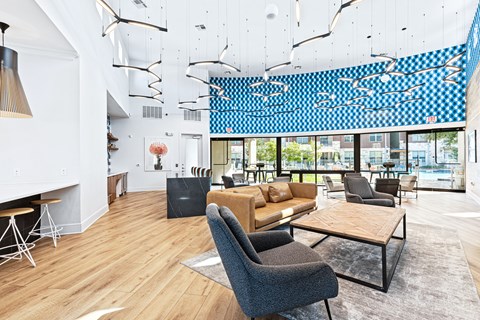 a living room with couches chairs and tables and a large window