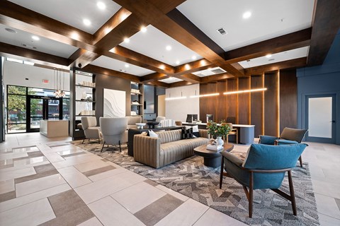 A spacious lobby with a variety of seating options and a marble floor.