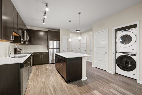 A modern kitchen with dark brown cabinets and a white countertop.
