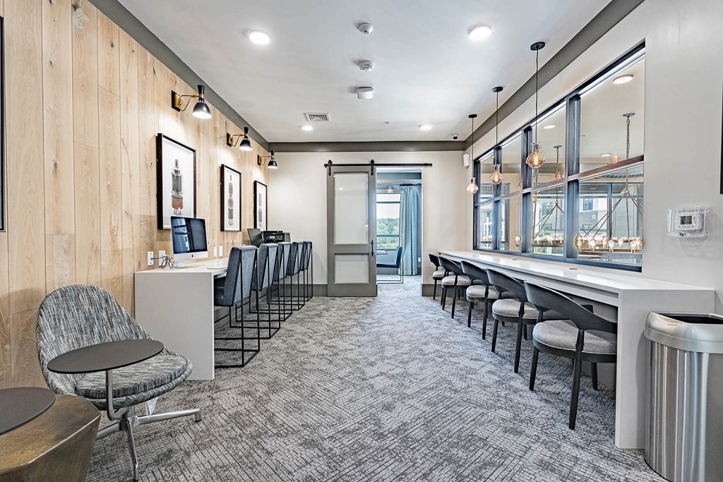 a room with a long table with chairs and a large window with a view of the city