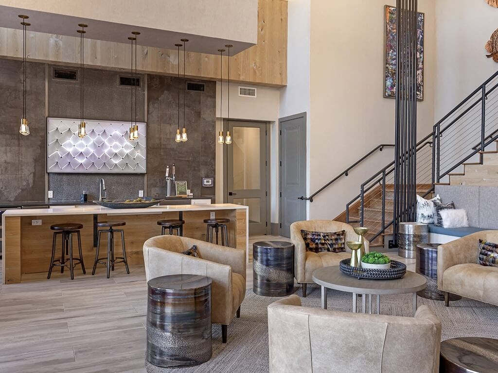 an open concept living room and kitchen with a staircase leading up to the second floor