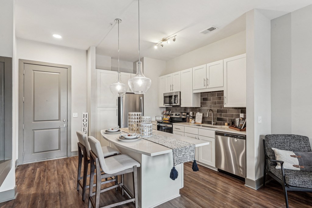 an open kitchen and dining area with a table and chairs