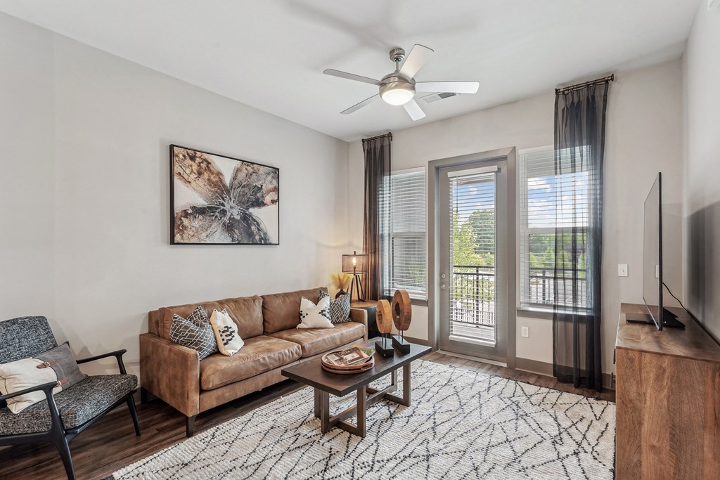 a living room with a couch and a ceiling fan