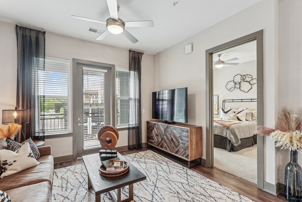 a living room with a large mirror and a couch and a table