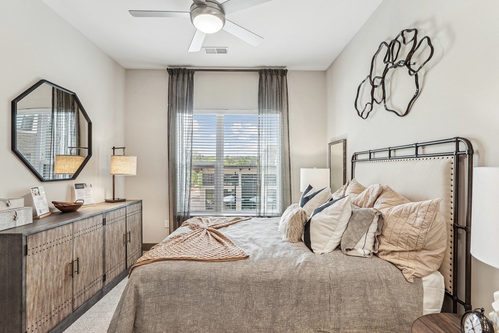 a bedroom with a large bed and a ceiling fan