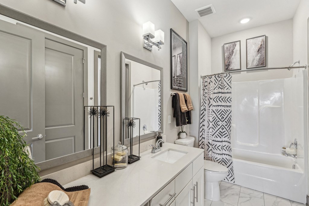 a white bathroom with a shower and a sink