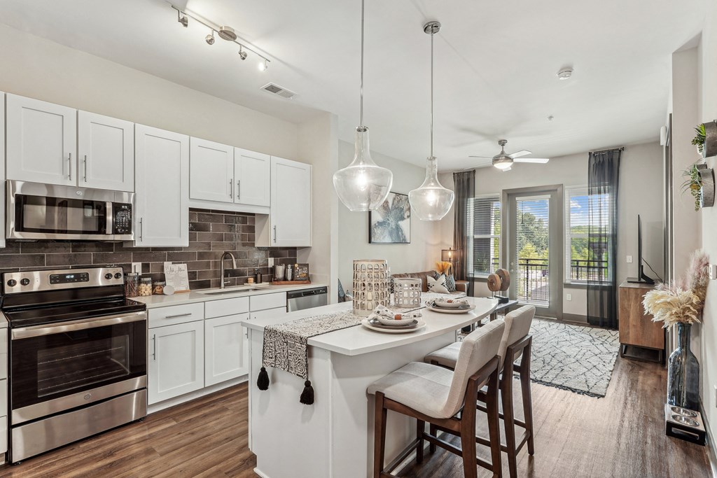 an open kitchen and dining area with a table and chairs
