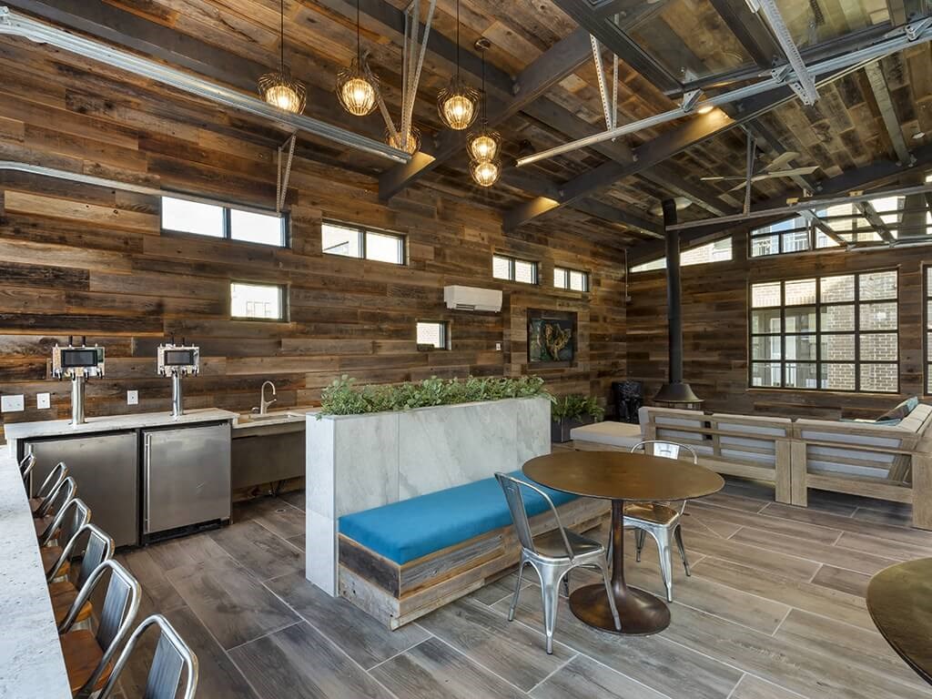 a kitchen and dining area with wooden walls and ceilings