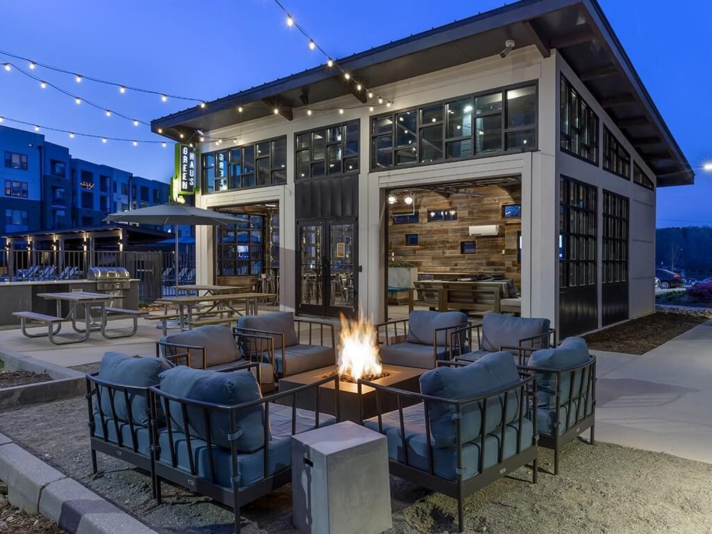 a fire pit and seating area outside of a building