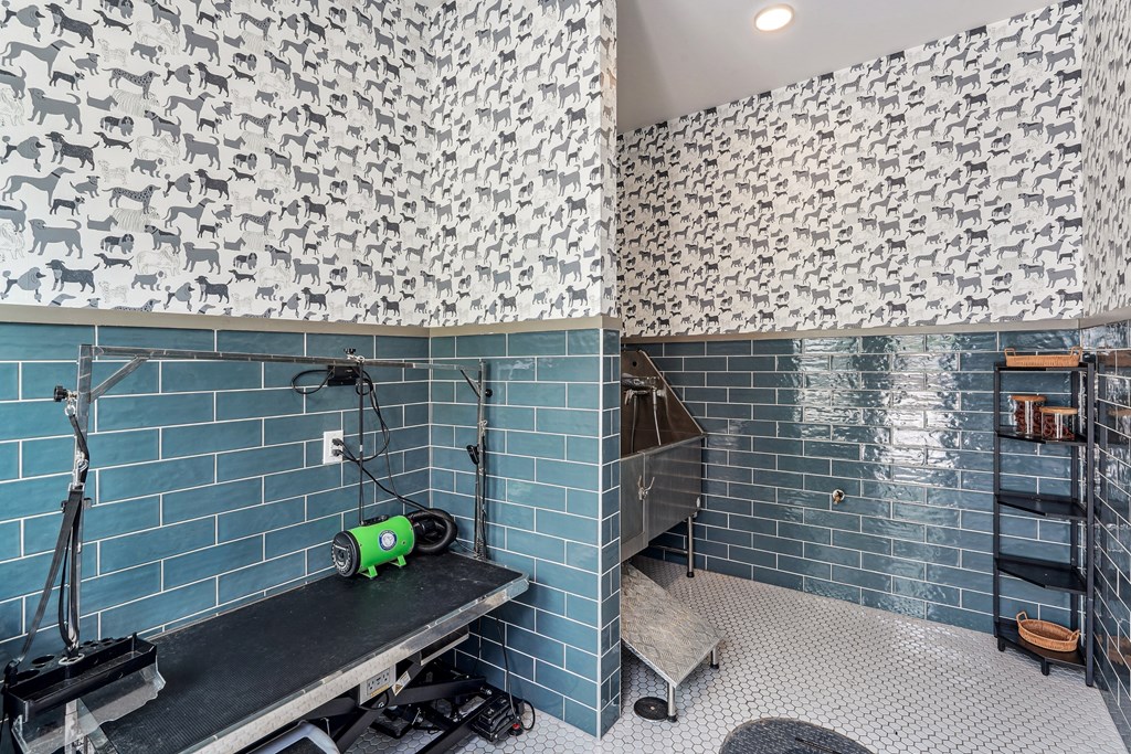 a blue tiled bathroom with a claw foot tub and a shower and a sink