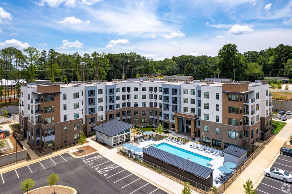 an aerial view of an apartment complex with a swimming pool