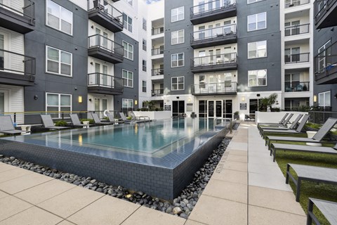 a swimming pool in front of an apartment building