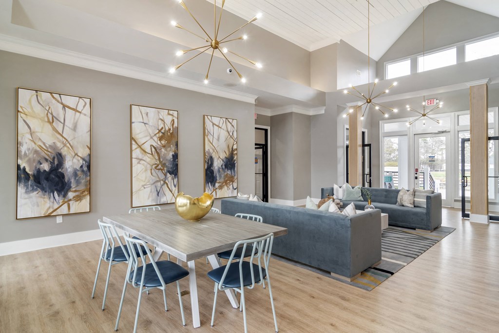 a dining room with a table and chairs and a living room with couches