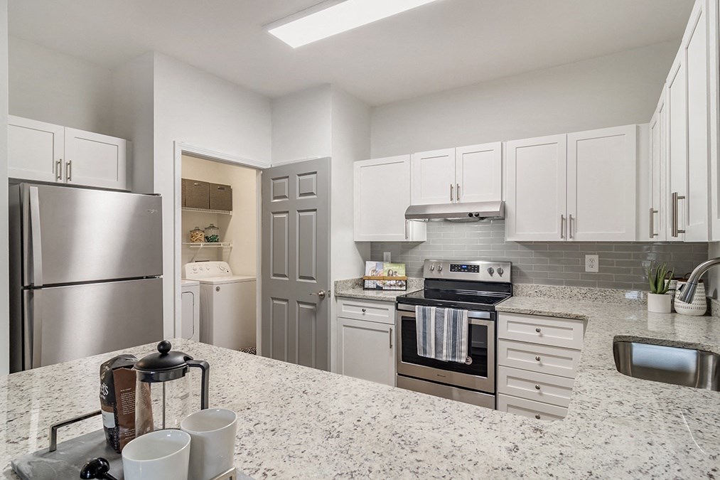 a kitchen with stainless steel appliances and granite counter tops