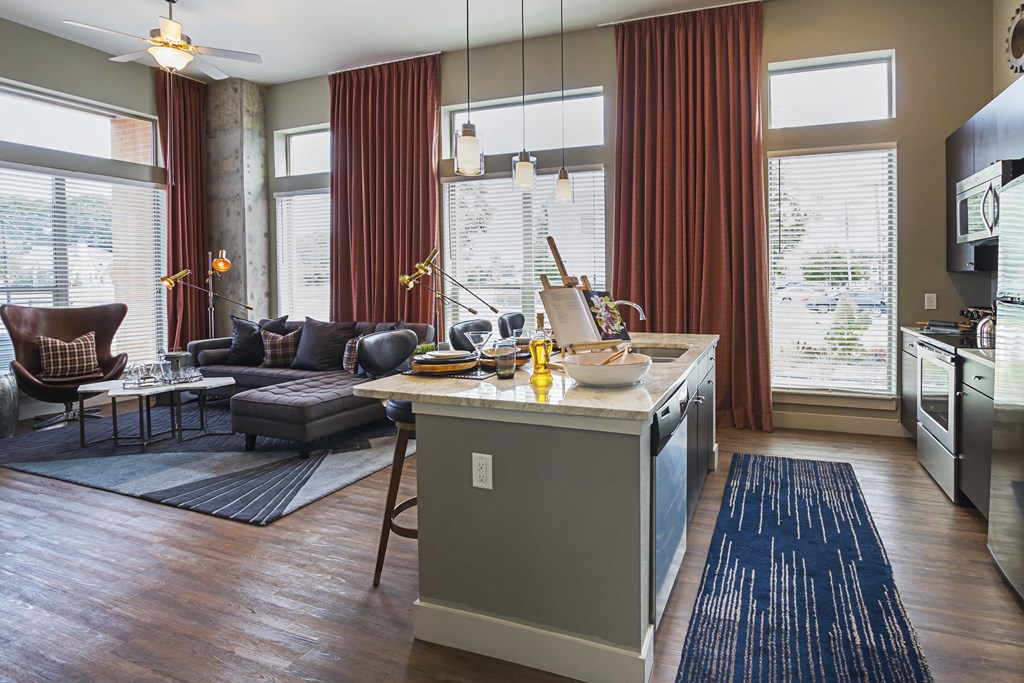 a living room with a kitchen and a dining room