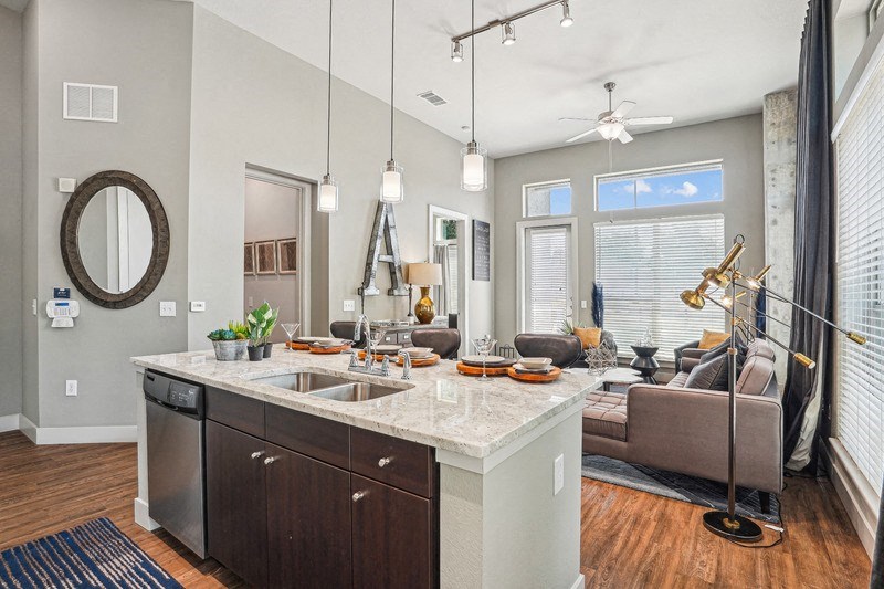 an open kitchen and living room with a large window