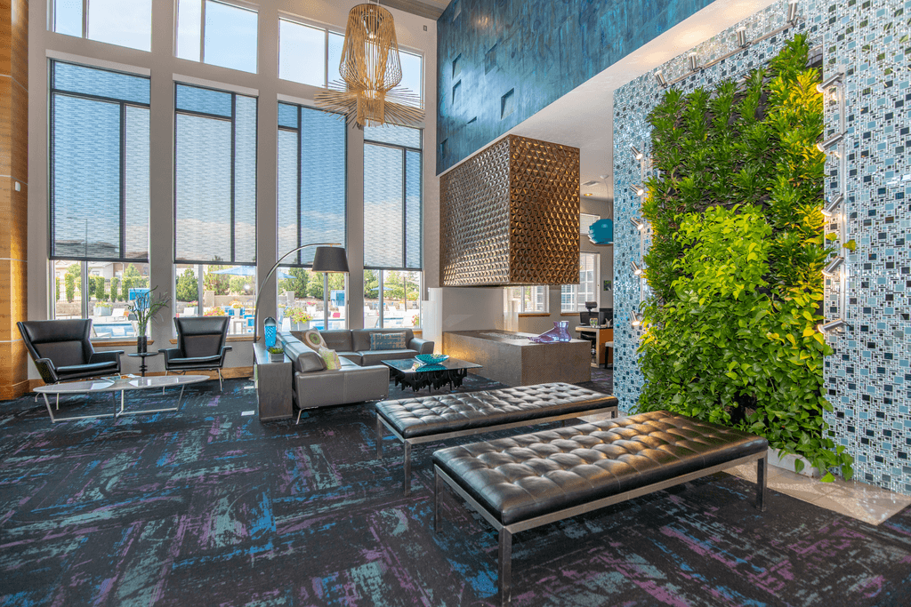 A living wall in a room with a grey sofa.