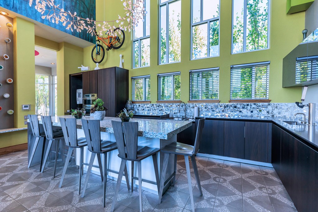 A dining room with a table and chairs.