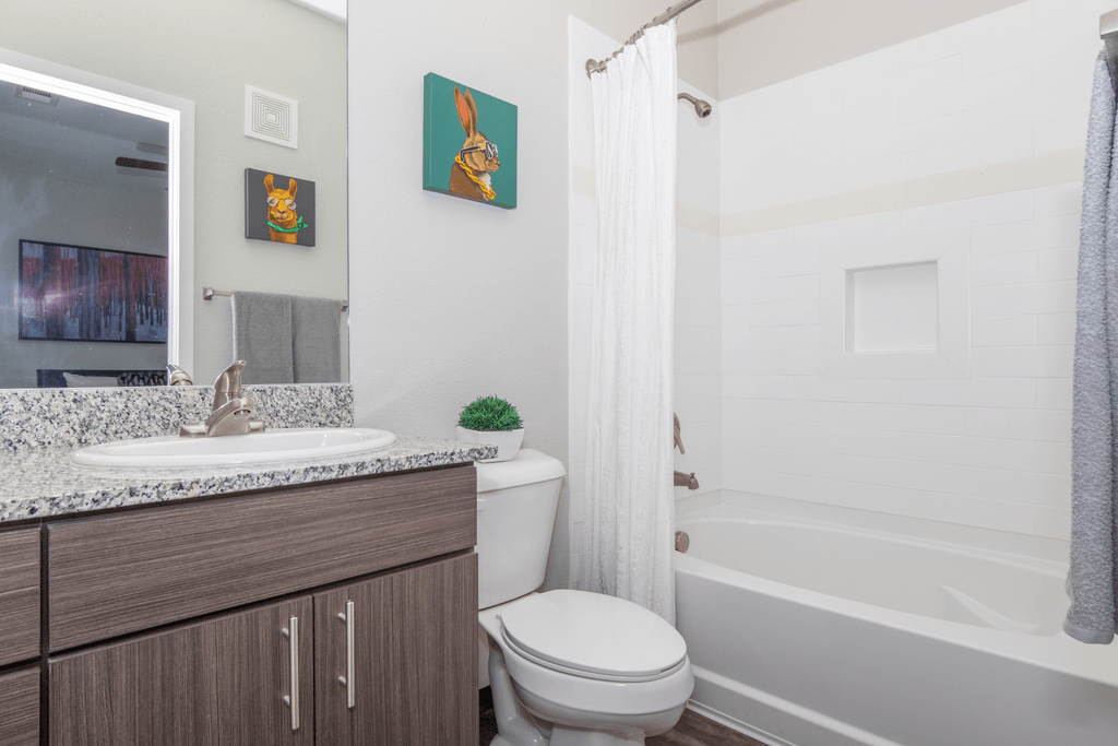 A bathroom with a toilet, sink, and bathtub.