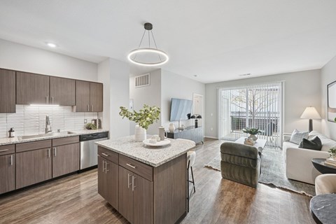 A modern kitchen with wooden cabinets and a marble countertop.