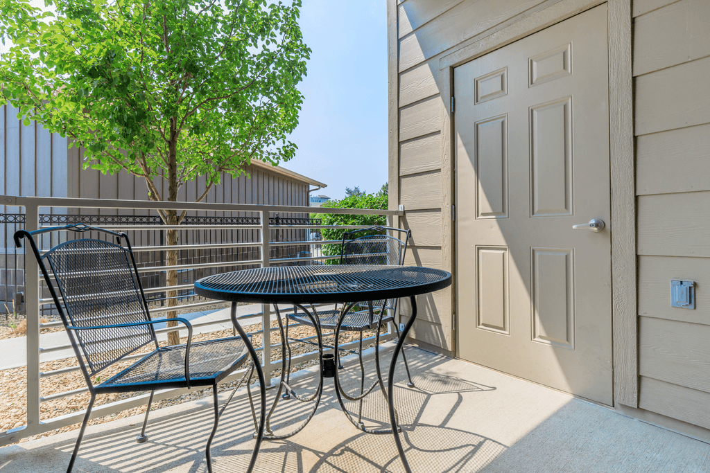 A patio with a table and chairs is shown.