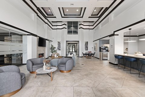 A modern living room with a skylight and a kitchen in the background.