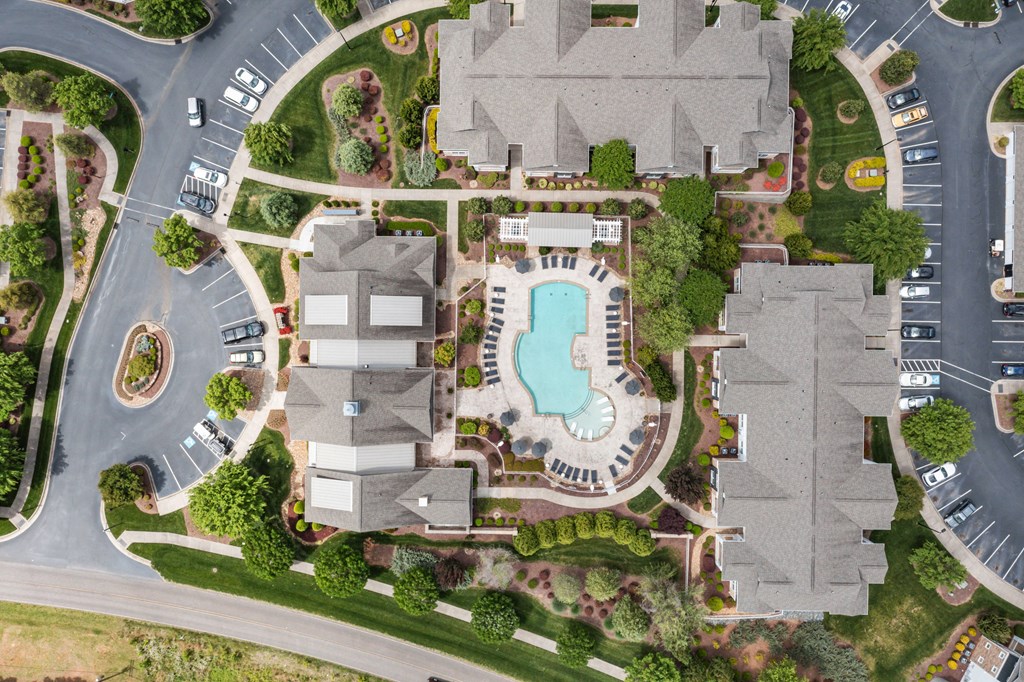 arial view of a mansion with a swimming pool and parking lot