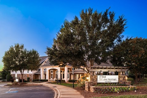 A large building with a sign that says "Belt Lake Norman" in front of it.