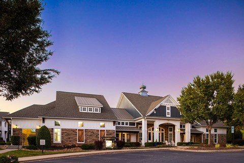 A large building with a parking lot in front of it.