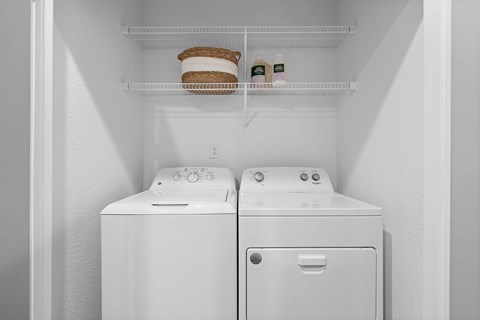 A white refrigerator with two toasters on the door.