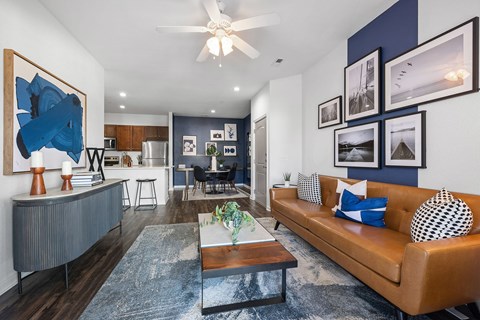 A living room with a brown couch and a coffee table.