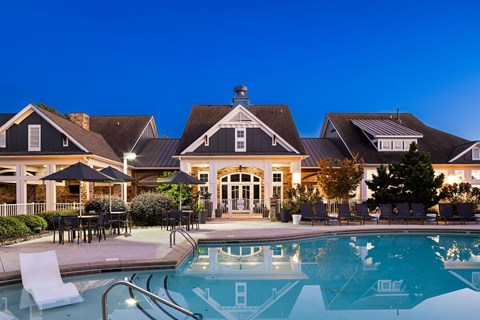 A large house with a pool in front.