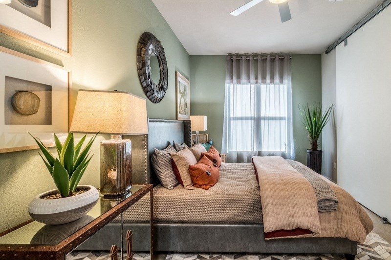 a bedroom with green walls and a bed with pillows