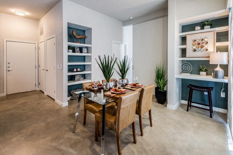 a dining room with a glass table and chairs