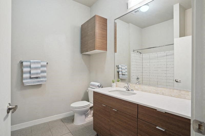 a bathroom with a sink toilet and a mirror