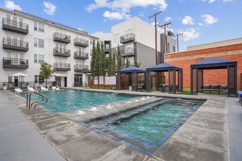 a swimming pool in front of an apartment building