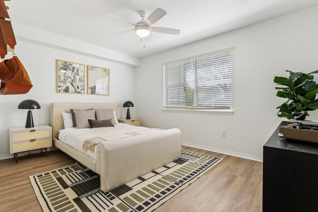 a bedroom with a bed and a ceiling fan