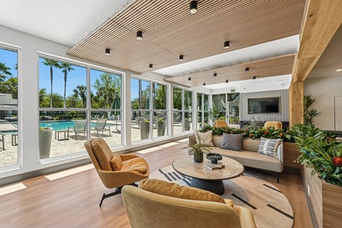 A living room with a yellow chair and a round table.