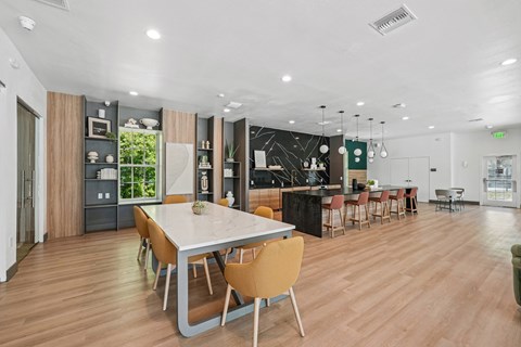 A modern dining room with a large table and chairs.