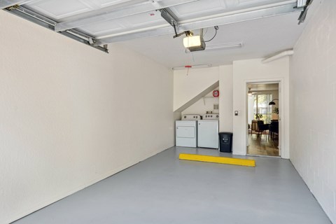 A large empty room with a yellow line on the floor.