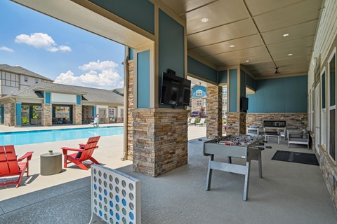 the preserve at ballantyne commons clubhouse with pool and table with chairs and tv