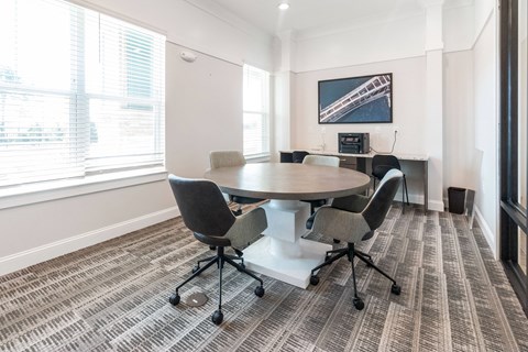 a meeting room with a table and chairs