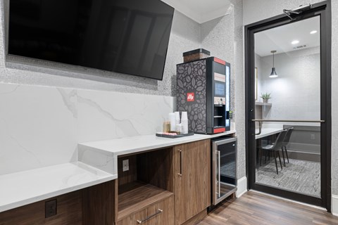 A modern kitchen with a refrigerator and a microwave.