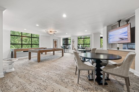 A modern dining room with a large table and chairs.