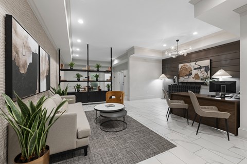 A modern living room with a grey carpet and a white sofa.