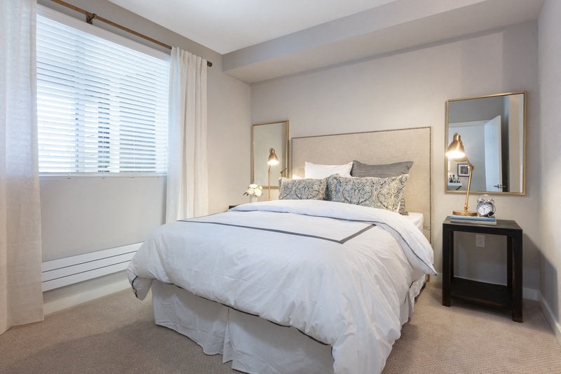 a bedroom with a large bed and a window