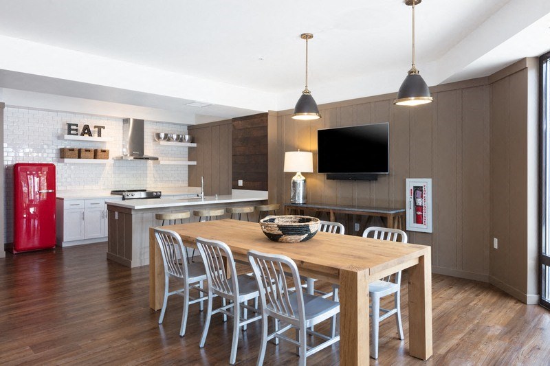 a kitchen and dining room with a table and chairs