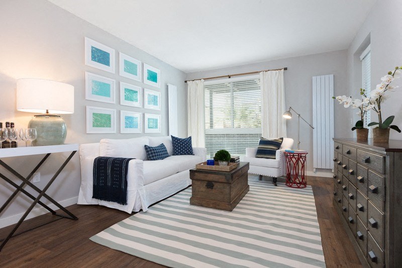 a living room with a white couch and a rug