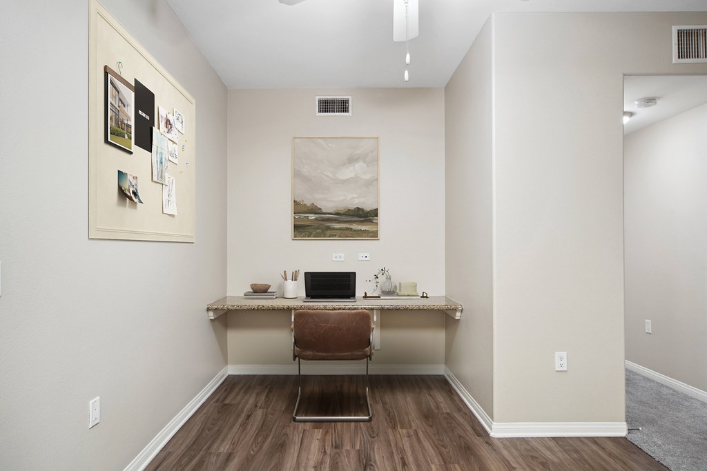 A room with a desk and a chair.
