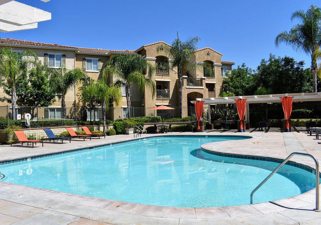 a large swimming pool in front of an apartment building